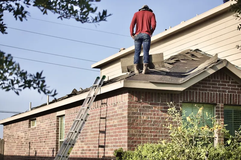 Professional roofer working on a residential roof in Larkington